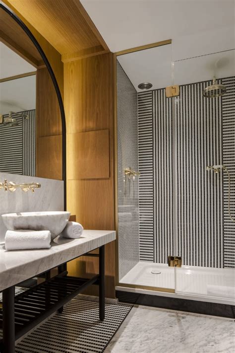 A list of modern bathroom wall decor ideas filled with funny prints, wall plaques, industrial shelving, modern geometric tiles, and quirky toilet paper holders. How to Attain an Art Deco Look in Your Bathroom - Amberth