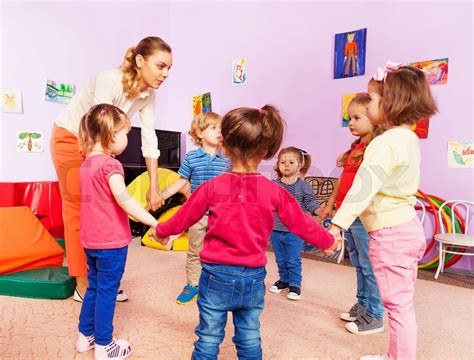 Teacher And Group Of Kids In Kindergarten Stock Image Colourbox