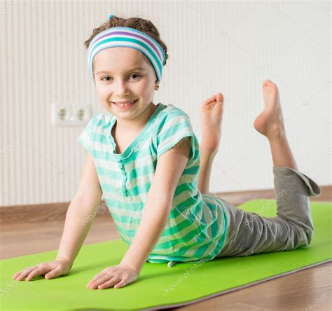 Little Girl Doing Gymnastic Exercises — Stock Photo © Tan4ikk 21259203