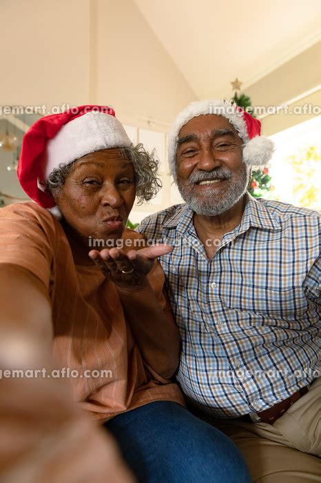 Happy African American Couple Wearing Santa Hats Having Video Call At