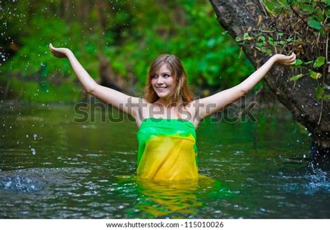 Female Woman Nude Model Standing Under The Rain Waist Deep In Water On A Green Background Of