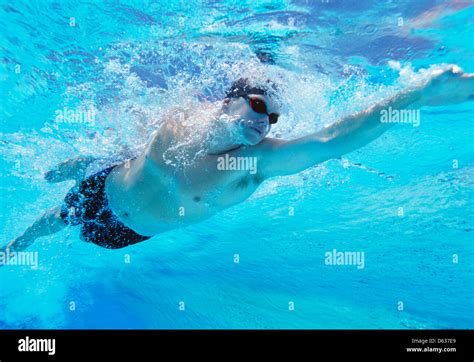Underwater Shot Of Professional Male Thlete Swimming In Pool Stock