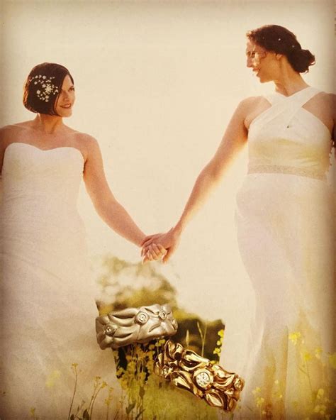 Two Women In White Dresses Holding Hands