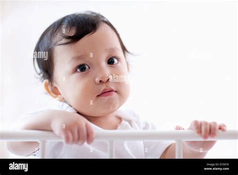 A Baby Inside A Crib Stock Photo Alamy