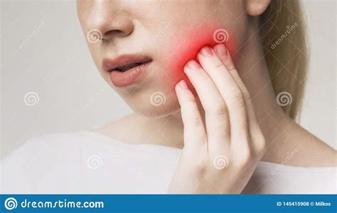 Woman Suffering From Toothache Touching Inflamed Cheek Stock Photo