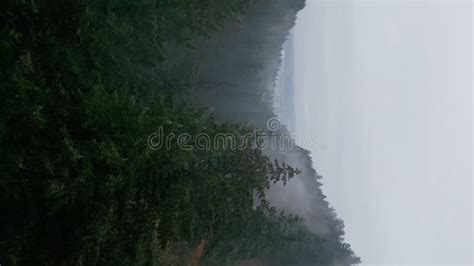 Vertical Aerial View Of Rainy Weather In Mountains Fog Blowing Over