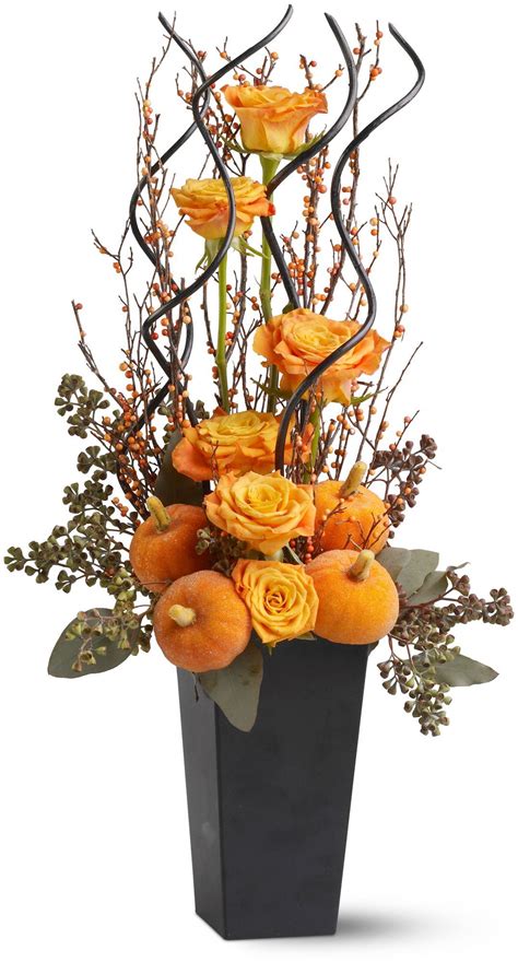 An Arrangement Of Orange Flowers In A Black Vase On A White Background