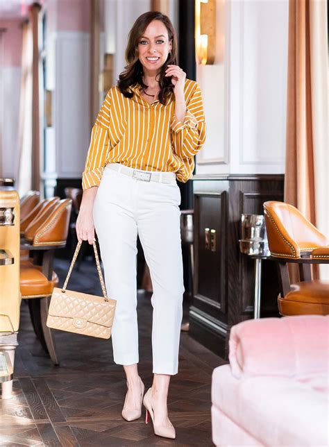 Sydne Style Shows Office Outfit Ideas In White Pants And Stripe Button Down Shirt Officeoutfits