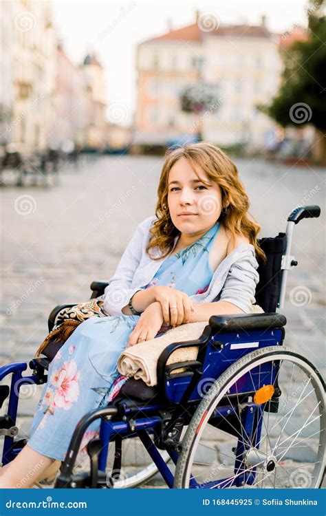 Retrato De Cerca De Una Mujer Discapacitada Muy Joven Sonriendo En Silla De Ruedas Al Fondo De