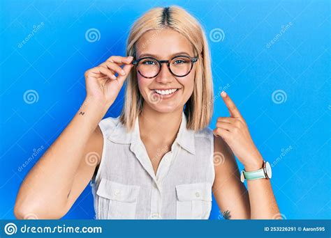 Beautiful Blonde Woman Wearing Glasses Smiling Happy Pointing With Hand And Finger Stock Image