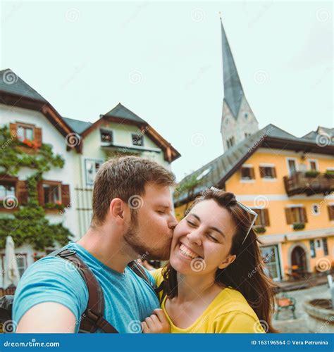 Smiling Lovely Couple Taking Selfie At Hallstatt City Central Square
