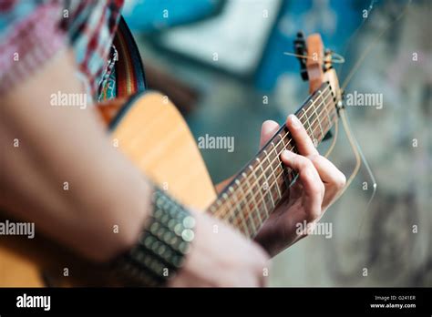 Closeup Portrait Of A Male Hands Playing On Guitar Outdoors Stock Photo