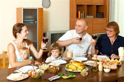 Retrato De La Familia Feliz Junto Sobre La Mesa De Comedor Imagen De