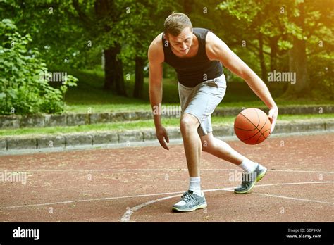 Young Male Basketball Player Running With Ball On Court Stock Photo Alamy