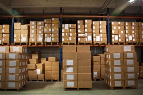 Large Number Of Boxes Stacked In Warehouse Stock Photo Download Image