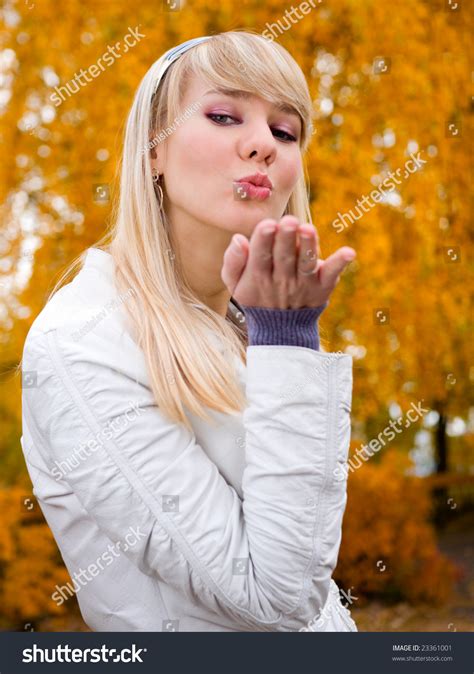 Pretty Girl Throwing A Kiss Autumn Park Background Shallow Dof