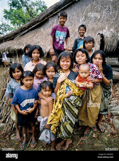 Indonesia Bali Village Women And Children Posing Outside Traditional