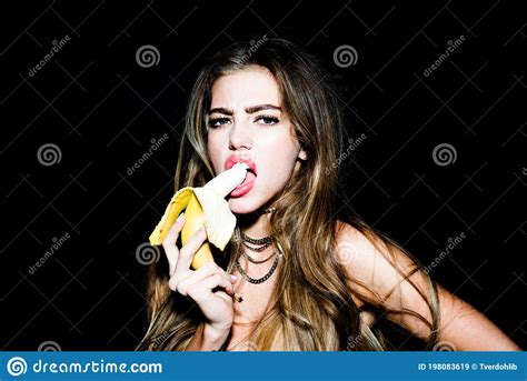 Portrait Of Seductive Young Woman Eating Banana Tropical Fruits