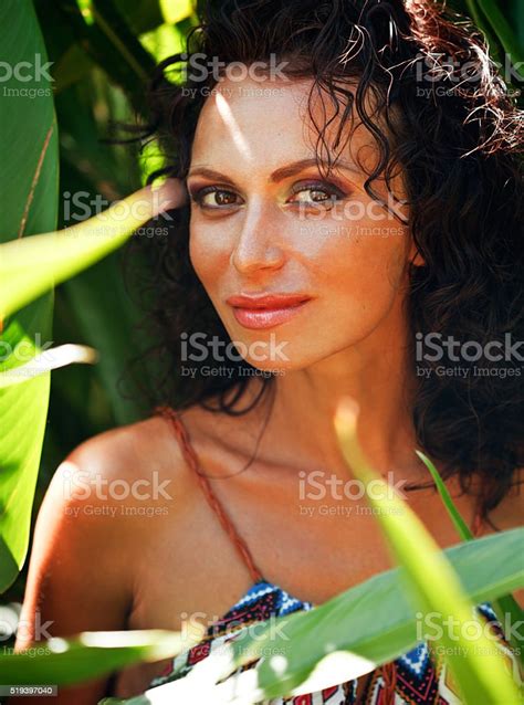 Middle Aged Brunette Elegant Woman With Green Leaf In Exotic Stock
