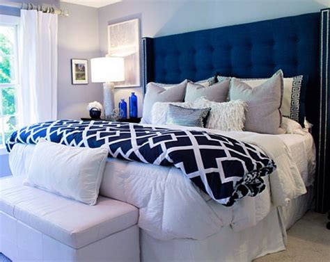 Sophisticated bedroom features a blue velvet headboard with silver nailhead trim on bed dressed in white and blue stitched hotel bedding and a navy cat's cradle pillow next to a gray nightstand adorned with brass. Headboard Ideas: 20+ Best & Cool Design For Your Beauty ...