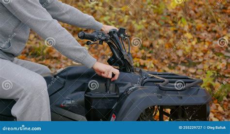 Close Up View Of A Guy In A Gray Opposite Suit Riding An Atv Stock