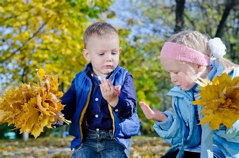 Boy And Girl Holding Autumn Leaves Stock Image Colourbox