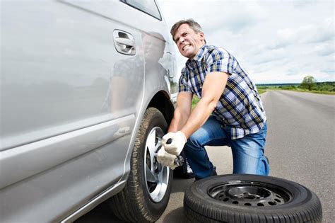 Premium Photo Man Changing A Spare Tire Of Car
