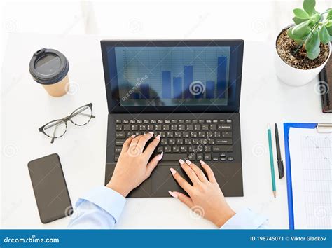 Top View Of Businesswoman S Hands Typing On A Laptop On Modern White