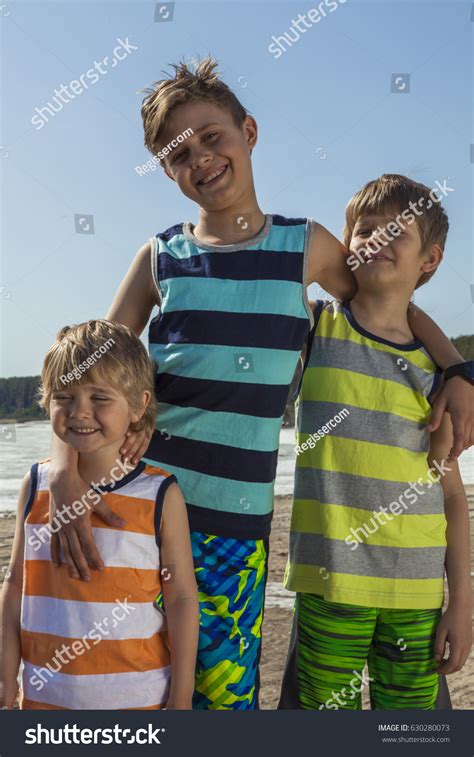 Three Happy Boys Hugging On Beach Stock Photo 630280073 Shutterstock