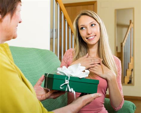 Mature Mother Presenting Gift In Box To Girl Stock Photo Image Of