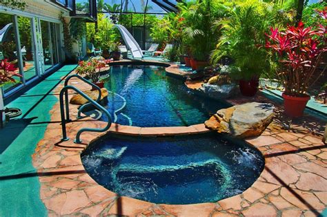 Indoor swimming pool with a movable part of the roof and walls. Super private tropical garden home with waterfall pool ...
