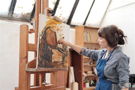 Woman Artist Paints A Picture On Canvas Bright Art Studio With A Large