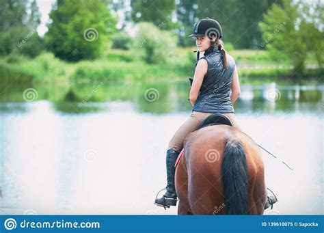 Teenage Girl Riding Horseback To The River At Early Morning Stock Image