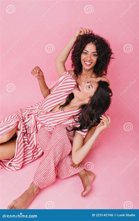 Cheerful Attractive Girls Rejoice And Laugh At Photo Shoot Portrait Of Pretty Models With Curly