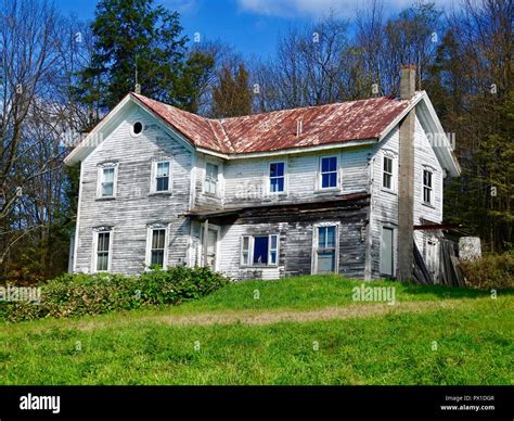 Old Abandoned Farm House White With Red Rusted Roof In Rural North