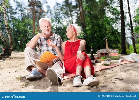 caring elderly wife sharing her apple with husband during picnic stock image image of feelings