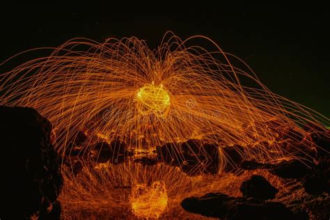 Burning Steel Wool On The Rock Near The River At Sam Phan Bok In