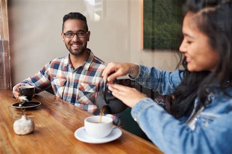 Two Young Friends Talking Together Over Coffee In A Cafe Stock Photo