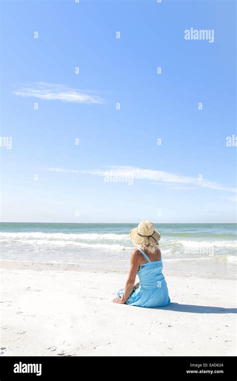 Mature Woman Sitting On Coquina Beach Anna Maria Island Florida Stock Photo Alamy