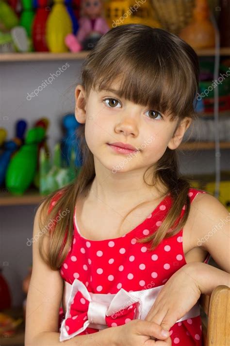 6 Years Old Girl Blond Hair Red Dress With White Polka Dots Stock