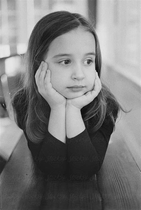 Black And White Portrait Of A Cute Young Girl Laying On A Bench By Stocksy Contributor Jakob