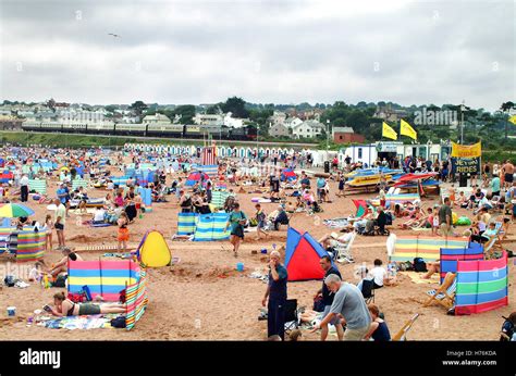 Holidaymakers On Beach With Steam Train In The Background At Goodrington Sands Near Paignton