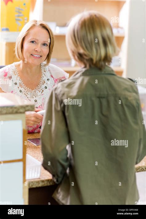 Librarian Checking Out Book In Hi Res Stock Photography And Images Alamy