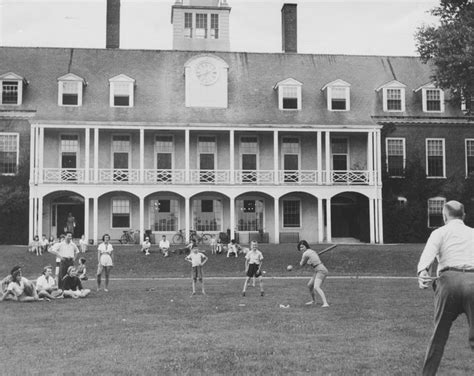 Black And White Photograph Of People Playing Baseball In Front Of A