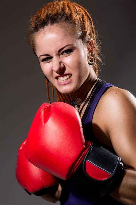 Beautiful Girl With Red Boxing Gloves Aggressive And Looking At Stock