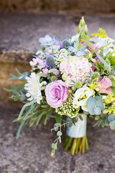 Bright orange flowers pop against a cool palette of green succulents and purple flowers. 25 Gorgeous Bridal Bouquets for Spring & Summer Weddings ...