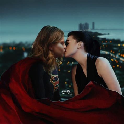 Two Women Kissing Each Other In Front Of A Cityscape