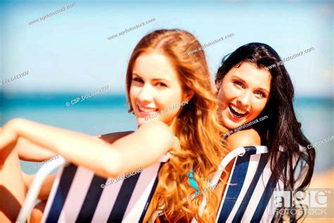 Girls Sunbathing On The Beach Chairs Stock Photo Picture And Low