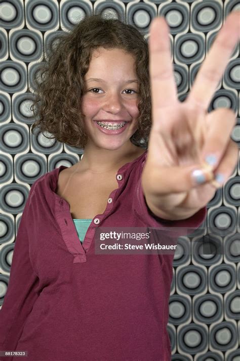 Girl Making The Peace Sign Hand Gesture High Res Stock Photo Getty Images