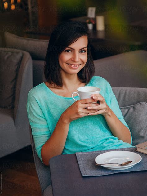 Attractive Young Woman Drinking Coffee Del Colaborador De Stocksy